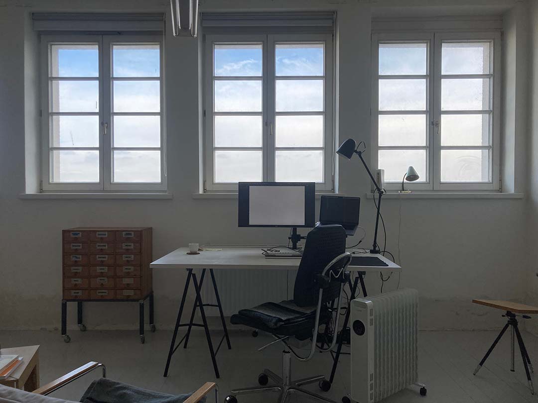 A studio with a view of a bright cloudy sky.